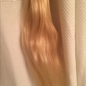 Light blonde hair clip extension.